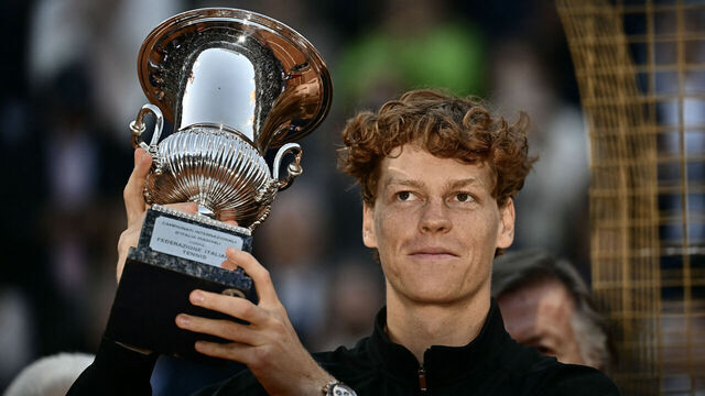 Italy's Jannik Sinner holds the trophy after winning the men's final of the ATP Rome Open tennis tournament against Norway's Casper Ruud at the Foro Italico in Rome on May 17, 2026.