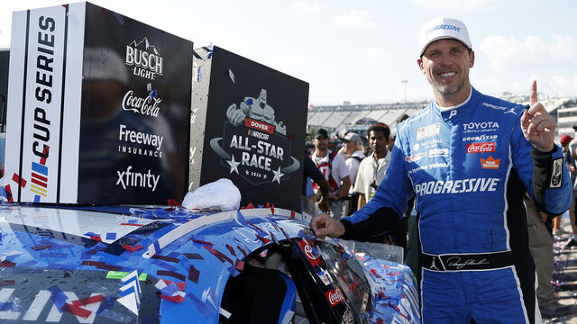 DOVER, DELAWARE - MAY 17: Denny Hamlin, driver of the #11 Progressive Insurance Toyota, poses with the winner sticker on his car in victory lane after winning the NASCAR Cup Series All-Star Race at Dover Motor Speedway on May 17, 2026 in Dover, Delaware.