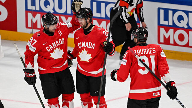 Canada's defender #29 Parker Wotherspoon celebrates scoring his team's fifth goal with teammates forward #87 Sidney Crosby and forward #91 John Tavares during the groupe B match between Canada and Denmark at the IIHF Ice Hockey Men's World Championship at BFC Arena, in Fribourg, Switzerland, on May 18, 2026.