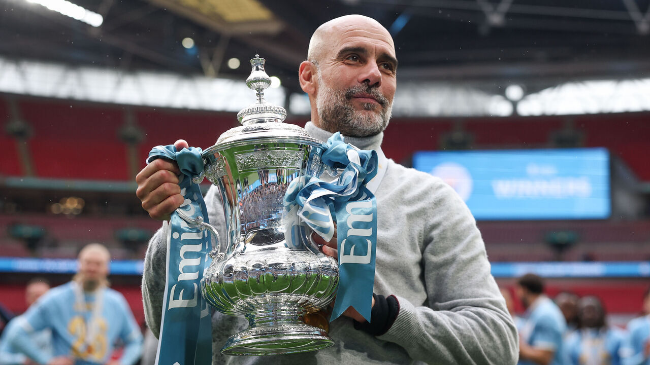 LONDON, ENGLAND - MAY 16: Pep Guardiola of Manchester City hold The FA Cup during the Emirates FA Cup Final match between Chelsea and Manchester City on May 16, 2026 in London, England.