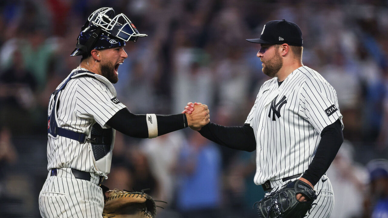 NEW YORK, NEW YORK - MAY 18: J.C. Escarra #25 and David Bednar #53 of the New York Yankees celebrate after the final out against the Toronto Blue Jays at Yankee Stadium on May 18, 2026 in the Bronx borough of New York City. The New York Yankees won 7-6.