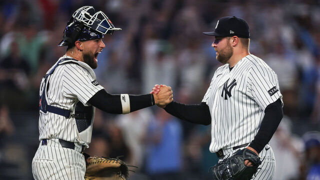 NEW YORK, NEW YORK - MAY 18: J.C. Escarra #25 and David Bednar #53 of the New York Yankees celebrate after the final out against the Toronto Blue Jays at Yankee Stadium on May 18, 2026 in the Bronx borough of New York City. The New York Yankees won 7-6.