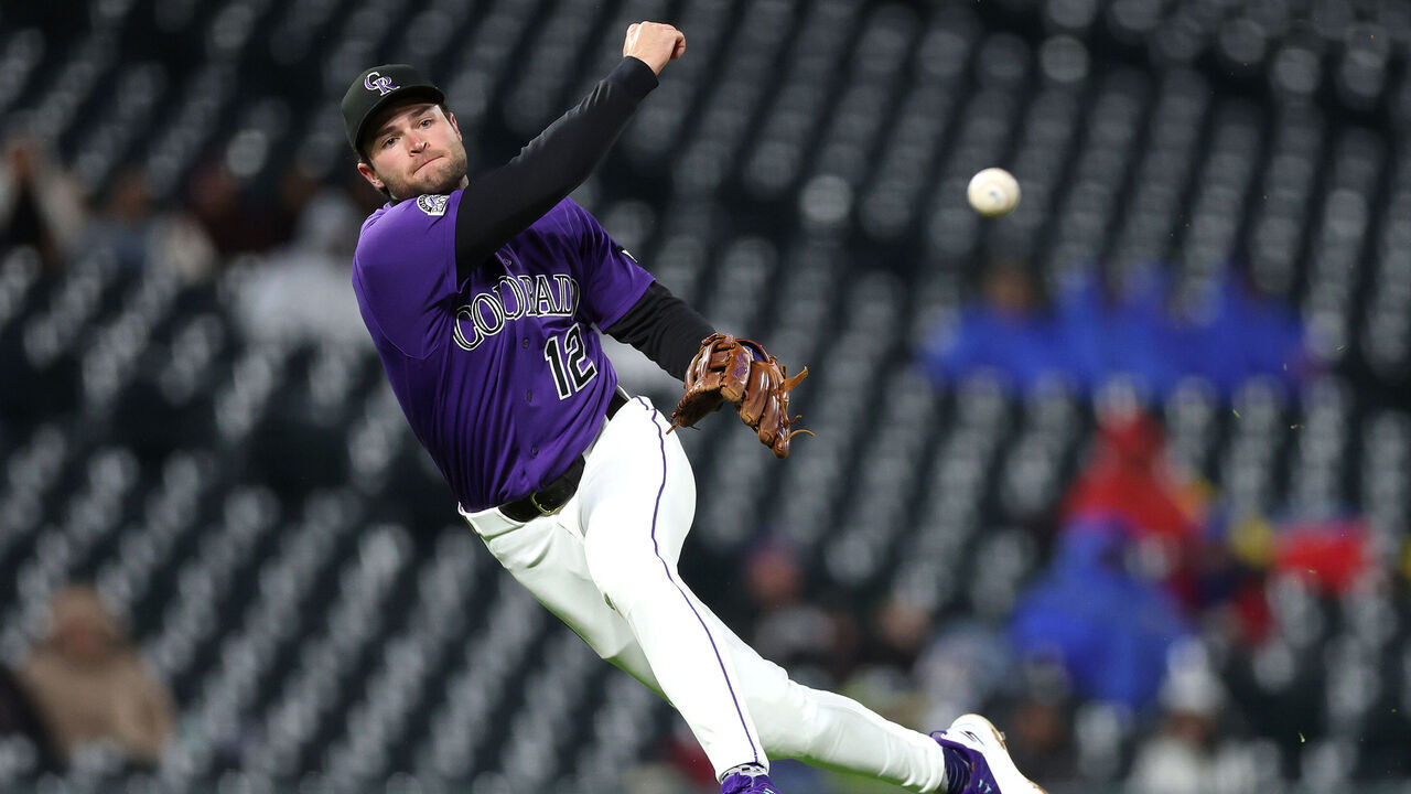 DENVER, COLORADO - MAY 18: Kyle Karros #12 of the Colorado Rockies throws to first base on a hit by Ezequiel Duran of the Texas Rangers during the sixth inning at Coors Field on May 18, 2026 in Denver, Colorado.