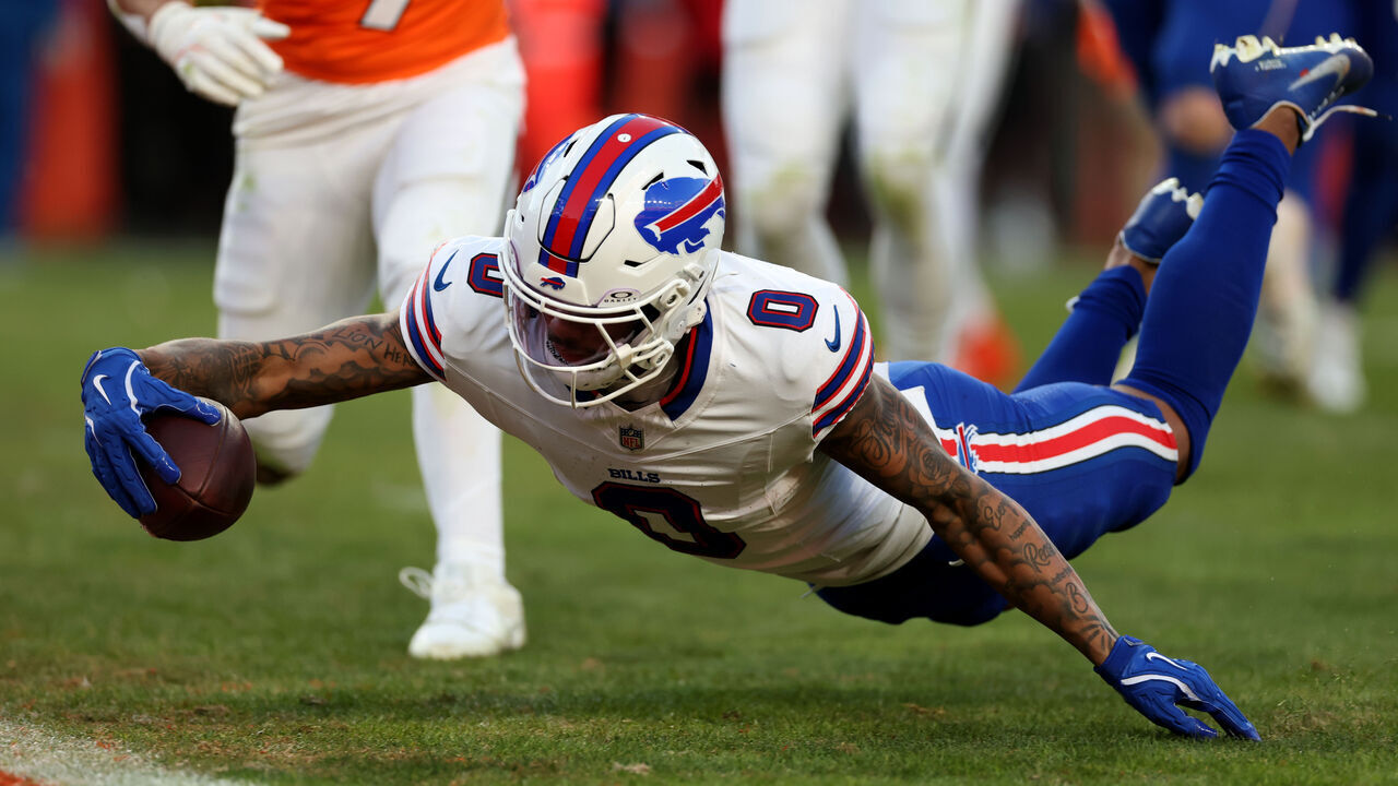 DENVER, COLORADO - JANUARY 17: Keon Coleman #0 of the Buffalo Bills scores a 10 yard touchdown against the Denver Broncos during the third quarter in the AFC Divisional Playoff game at Empower Field At Mile High on January 17, 2026 in Denver, Colorado.