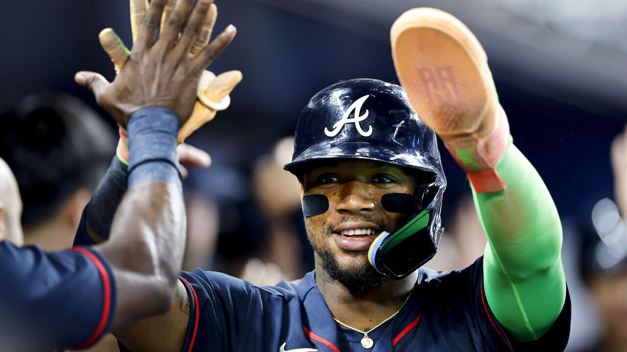 MIAMI, FLORIDA - MAY 19: Ronald Acuña Jr #13 of the Atlanta Braves high fives teammates after scoring during the eighth inning against the Miami Marlins at loanDepot park on May 19, 2026 in Miami, Florida.