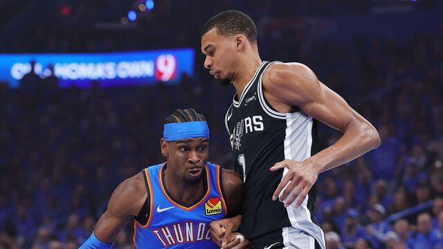 OKLAHOMA CITY, OKLAHOMA - MAY 18: Shai Gilgeous-Alexander #2 of the Oklahoma City Thunder drives to the basket against Victor Wembanyama #1 of the San Antonio Spurs during the first quarter in Game One of the NBA Western Conference Finals at Paycom Center on May 18, 2026 in Oklahoma City, Oklahoma.