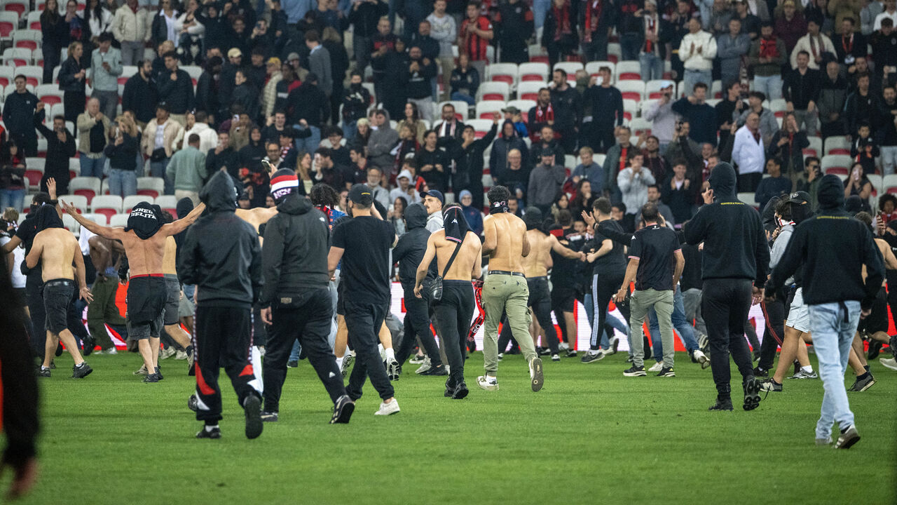 Nice supporters invade the pitch at the end of the French L1 football match between OGC Nice and FC Metz at the Allianz Riviera Stadium in Nice, south-eastern France, on May 17, 2026.