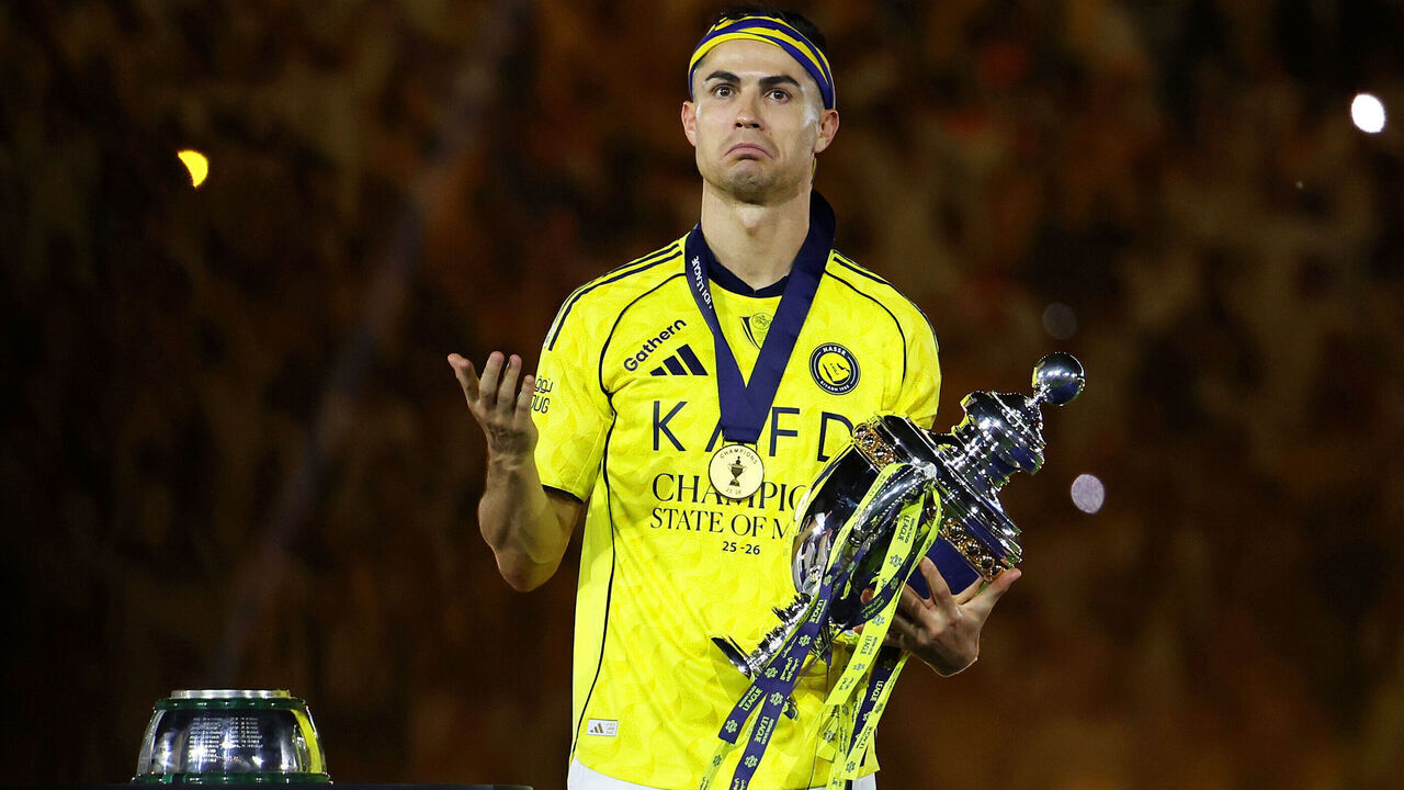 RIYADH, SAUDI ARABIA - MAY 21: Cristiano Ronaldo of Al Nassr celebrates with the Saudi Pro League Trophy following the Saudi Pro League match between Al Nassr and Damac at Al Awwal Park on May 21, 2026 in Riyadh, Saudi Arabia.