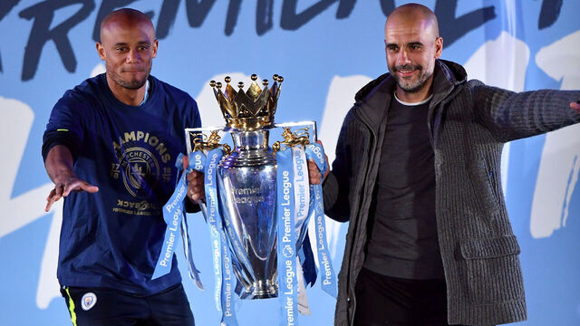 Manchester City's Vincent Kompany and manager Pep Guardiola on stage with the trophy during the celebrations at the Etihad Stadium after securing the Premier League title earlier in the day with their win at Brighton and Hove Albion.