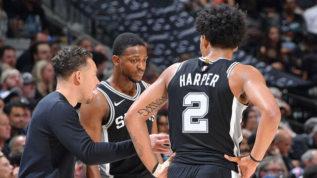 SAN ANTONIO, TX - MAY 12: Head Coach Mitch Johnson of the San Antonio Spurs, De'Aaron Fox #4 of the San Antonio Spurs, and Dylan Harper #2 of the San Antonio Spurs talk during the game against the Minnesota Timberwolves during Round Two Game Five of the 2026 NBA Playoffs on May 12, 2026 at the Frost Bank Center in San Antonio, Texas. Mandatory Copyright Notice: Copyright 2026 NBAE (Photos by Michael Gonzales/NBAE via Getty Images)