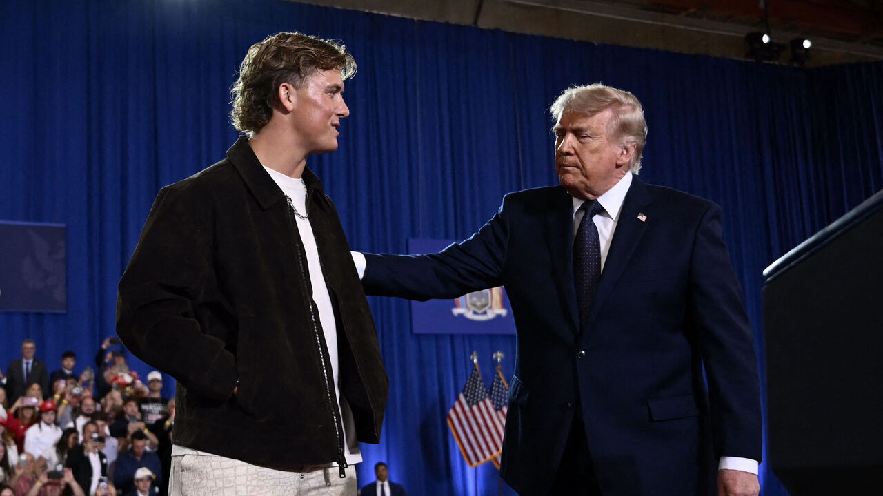 US President Donald Trump is welcomed by New York Giants quarterback Jaxson Dart before delivering a speech about the economy at Rockland Community College Fieldhouse in Suffern, New York, on May 22, 2026. Trump is the first sitting president to visit the northern New York City suburbs since Gerald Ford in 1976.