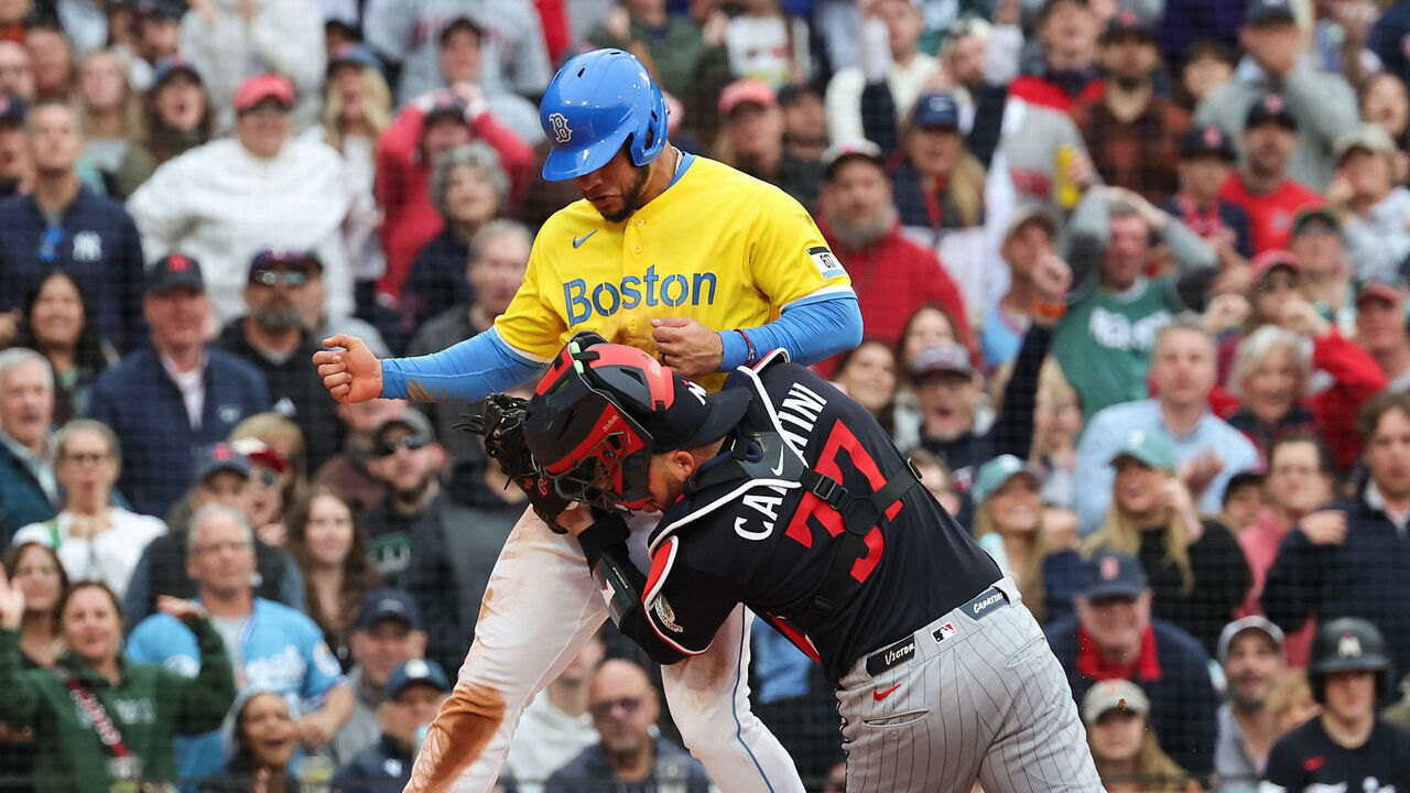 BOSTON, MASSACHUSETTS - MAY 23: Willson Contreras #40 of the Boston Red Sox is tagged out as he runs into catcher Victor Caratini #37 of the Minnesota Twins while attempting to score during the fourth inning at Fenway Park on May 23, 2026 in Boston, Massachusetts.