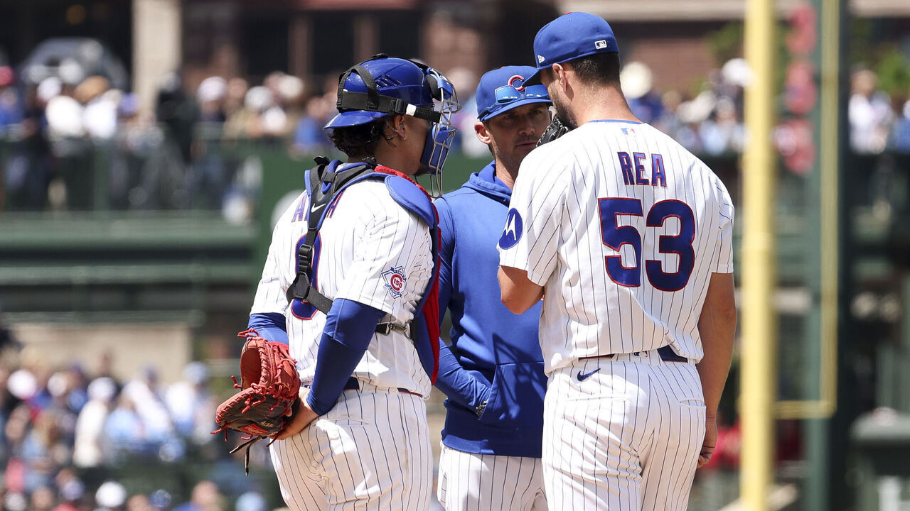 CHICAGO, ILLINOIS - MAY 23: Colin Rea #53, Miguel Amaya #9 and pitching coach Tommy Hottovy #68 of the Chicago Cubs meet on the mound during the fourth inning against the Houston Astros at Wrigley Field on May 23, 2026 in Chicago, Illinois.