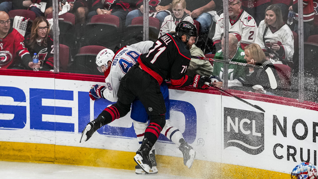 RALEIGH, NORTH CAROLINA - MAY 23: Taylor Hall #71 of the Carolina Hurricanes hits Lane Hutson #48 of the Montréal Canadiens onto the boards during the second period in Game Two of the Eastern Conference Final of the 2026 Stanley Cup Playoffs at Lenovo Center on May 23, 2026 in Raleigh, North Carolina.