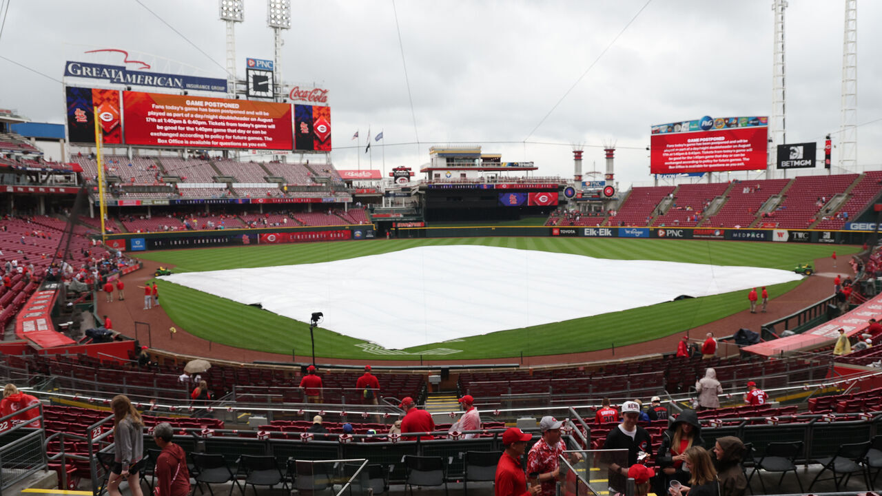 CINCINNATI, OHIO - MAY 24: Fans wait for the rain delay to end at the St. Louis Cardinals game against the Cincinnati Reds at Great American Ball Park on May 24, 2026 in Cincinnati, Ohio. The game was eventually postponed and rescheduled for August 17.
