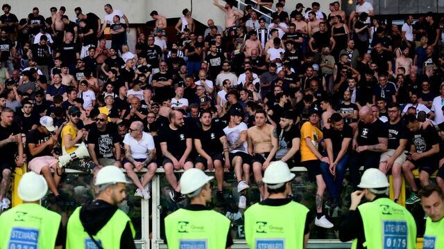 Juventus' supporters wait for the match to restart after a suspension during the Italian Serie A football match betweem Torino and Juventus FC at the Olympic Stadium Grande Torino in Turin on May 24, 2026.