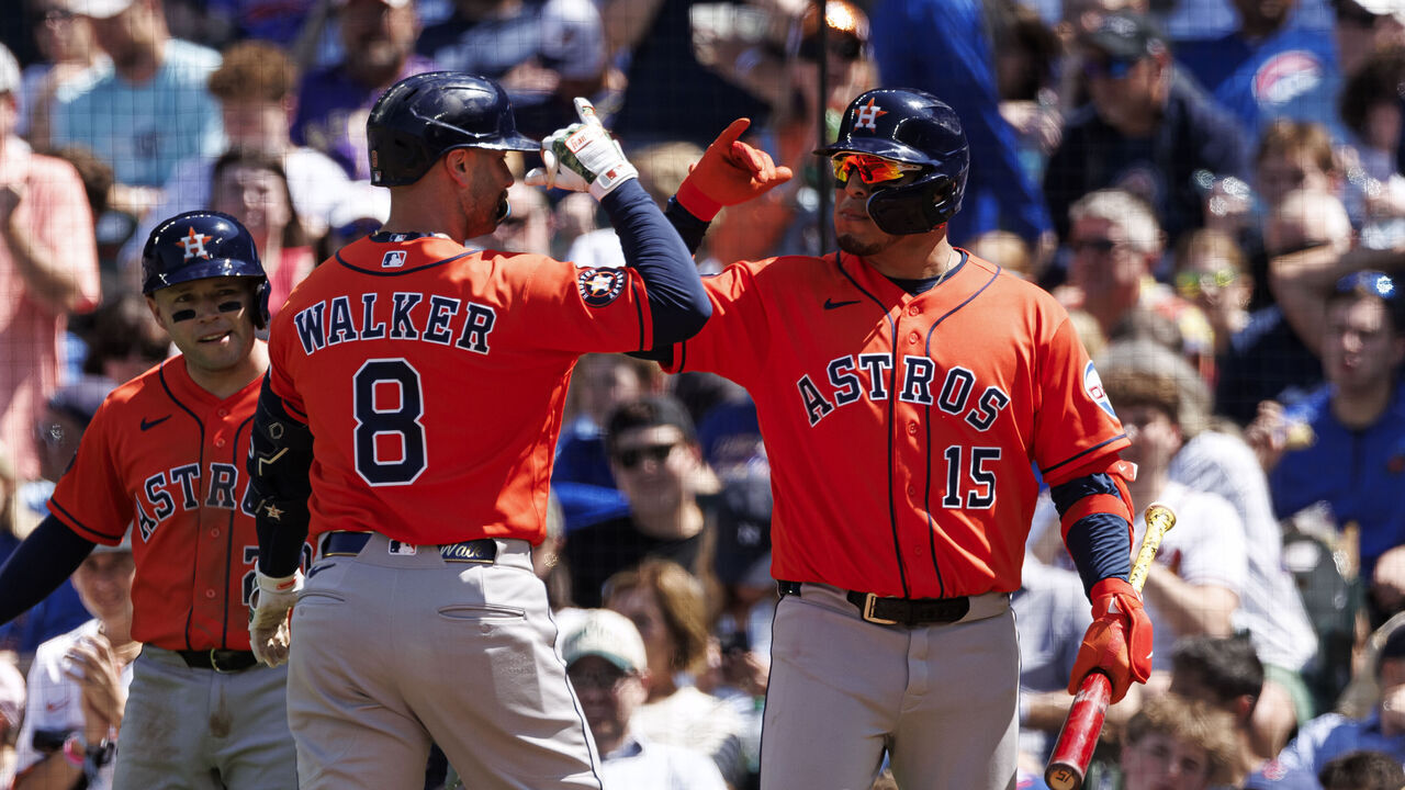 CHICAGO, ILLINOIS - MAY 24: Christian Walker #8 reacts with Isaac Paredes #15 of the Houston Astros after hitting a three run home run in the fifth inning of a game between the Houston Astros and the Chicago Cubs at Wrigley Field on May 24, 2026 in Chicago, Illinois.