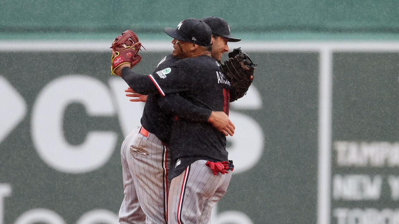 BOSTON, MASSACHUSETTS - MAY 24: Orlando Arcia #11 of the Minnesota Twins hugs Ryan Kreidler #5 after their 6-5 win over the Boston Red Sox at Fenway Park on May 24, 2026 in Boston, Massachusetts.