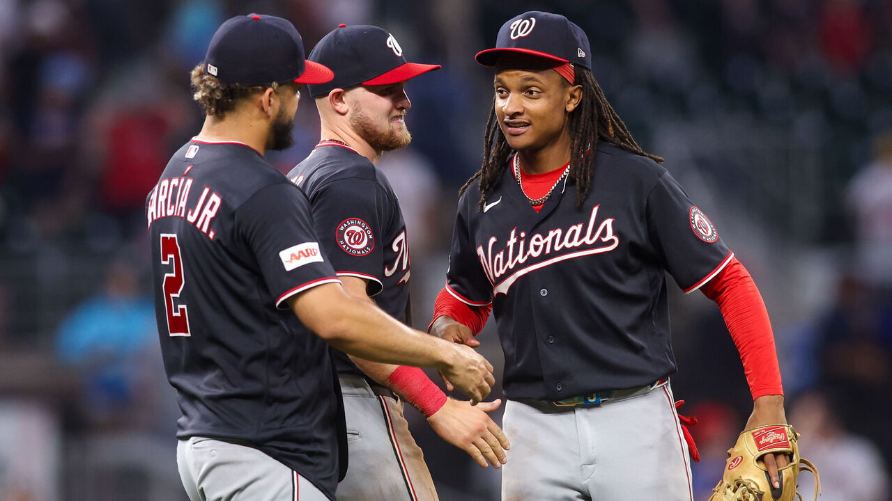 ATLANTA, GEORGIA - MAY 24: Luis García Jr. #2, Curtis Mead #45, and CJ Abrams #5 of the Washington Nationals celebrate after a 2-1 victory over the Atlanta Braves in the ninth inning at Truist Park on May 24, 2026 in Atlanta, Georgia.