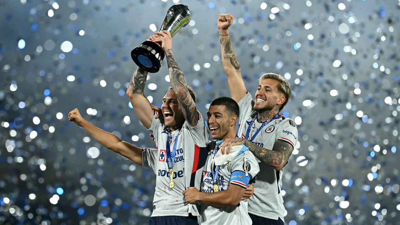 Cruz Azul's Argentine forward #29 Rodolfo Rotondi lifts the trophy with teammates after winning the Liga MX Clausura final second-leg football match between Pumas UNAM and Cruz Azul at Olimpico Universitario stadium in Mexico City on May 24, 2026.