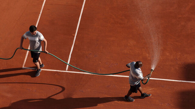 PARIS, FRANCE - MAY 25: Ground staff water the clay on court between games on Day Two of the 2026 French Open at Roland Garros on May 25, 2026 in Paris, France.