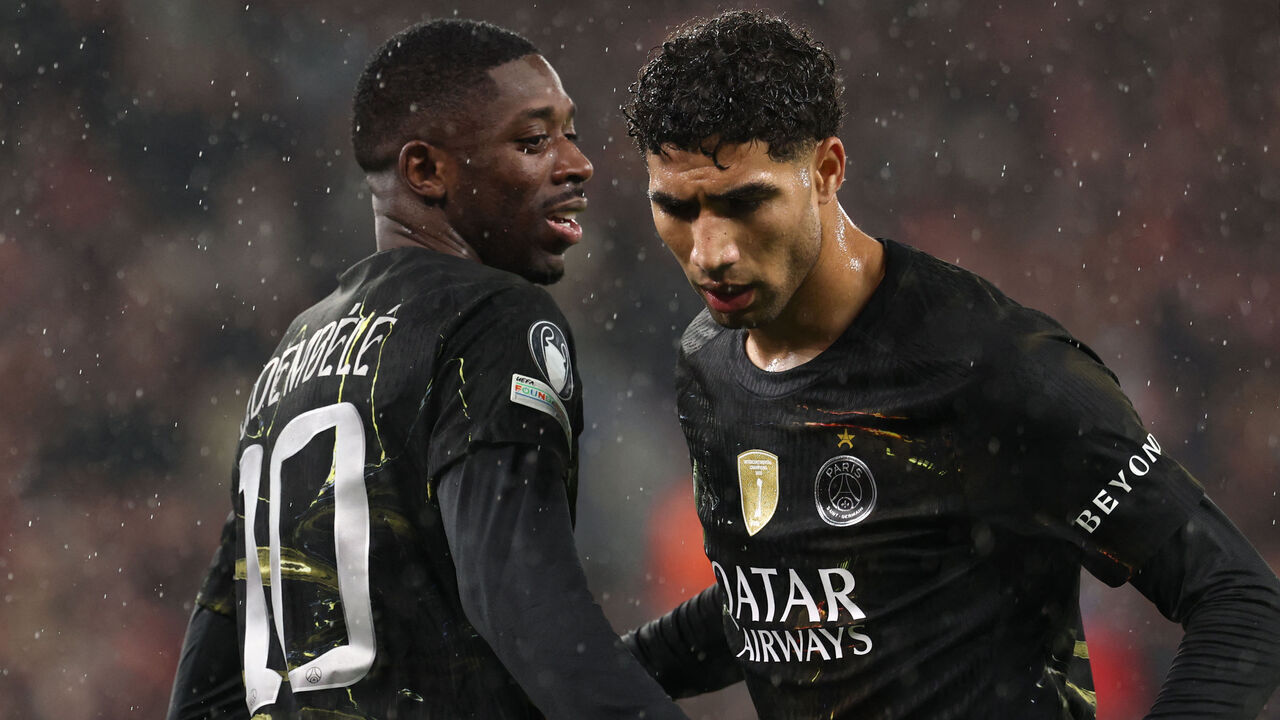 Paris Saint-Germain's French forward #10 Ousmane Dembele (L) celebrates with Paris Saint-Germain's Moroccan defender #02 Achraf Hakimi (R) after scoring the opening goal during the UEFA Champions League quarter final, second-leg football match between Liverpool and Paris Saint-Germain at Anfield in Liverpool, north west England on April 14, 2026.