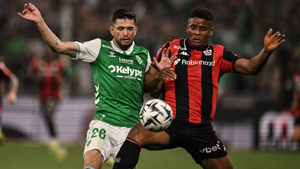 Nice's Spanish forward #90 Kevin Carlos (R) fights for the ball with Saint-Etienne's French defender #26 Julien Le Cardinal (L) during the French L1-L2 playoff football match between AS Saint-Etienne (L2) OGC Nice (L1) at the stade Geoffroy Guichard in Saint-Etienne, south-eastern France, on May 26, 2026.