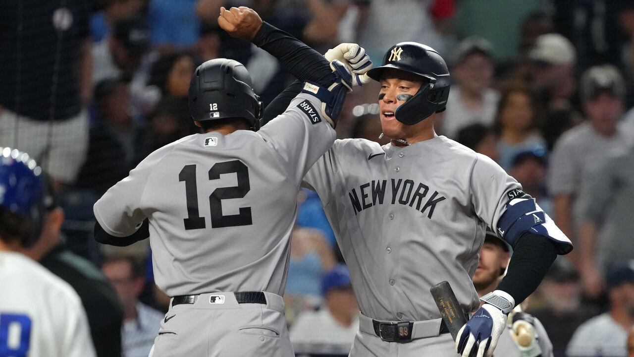 KANSAS CITY, MISSOURI - MAY 26: Trent Grisham #12 of the New York Yankees celebrates his home run with Aaron Judge #99 of the New York Yankees in the seventh inning against the Kansas City Royals at Kauffman Stadium on May 26, 2026 in Kansas City, Missouri.