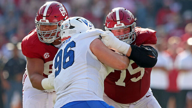 TUSCALOOSA, ALABAMA - NOVEMBER 22: Michael Carroll #64 and Wilkin Formby #75 of the Alabama Crimson Tide block Cole Silzer #96 of the Eastern Illinois Panthers during the first quarter of the game at Bryant-Denny Stadium on November 22, 2025 in Tuscaloosa, Alabama.