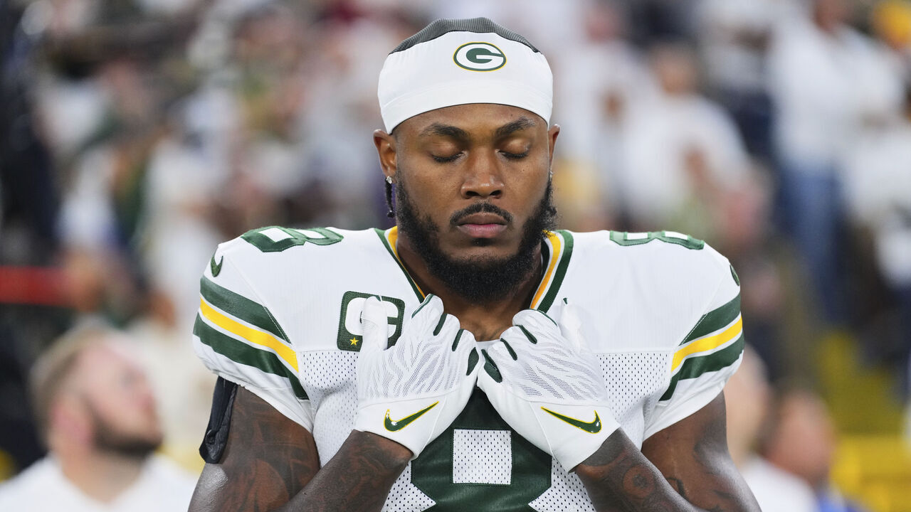 GREEN BAY, WI - SEPTEMBER 11: Josh Jacobs #8 of the Green Bay Packers looks on from the sideline during the national anthem prior to an NFL football game against the Washington Commanders during at Lambeau Field on September 11, 2025 in Green Bay, Wisconsin.