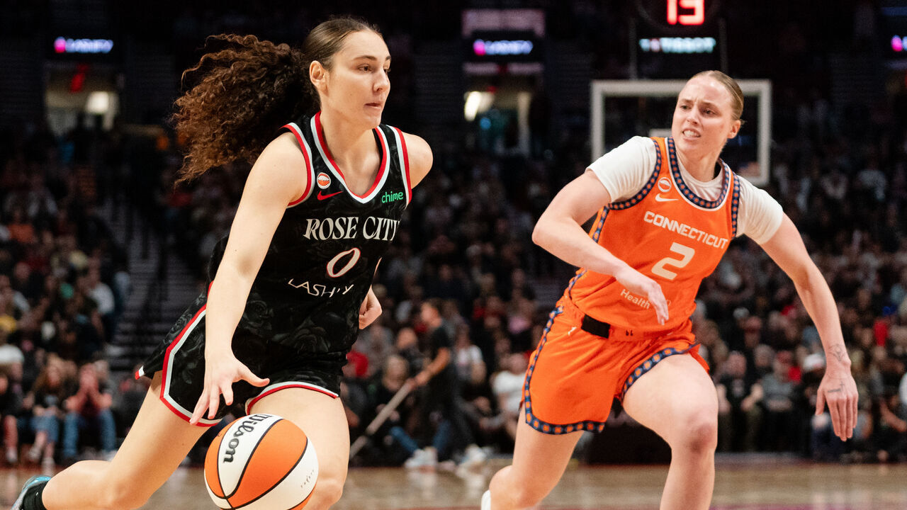 PORTLAND, OREGON - MAY 27: Guard Carla Leite #0 of the Portland Fire drives to the basket against guard Hailey Van Lith #2 of the Connecticut Sun during the second half of the game at Moda Center on May 27, 2026 in Portland, Oregon.
