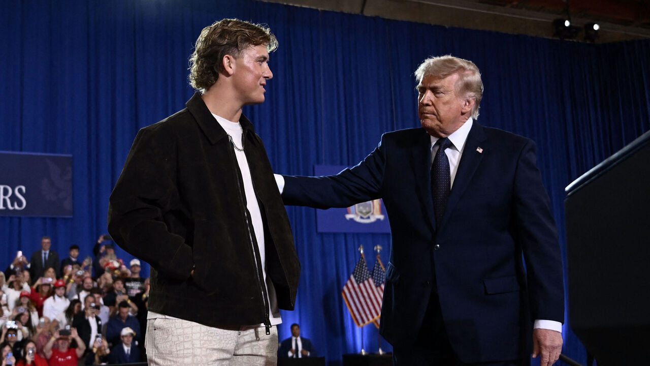 US President Donald Trump is welcomed by New York Giants quarterback Jaxson Dart before delivering a speech about the economy at Rockland Community College Fieldhouse in Suffern, New York, on May 22, 2026. Trump is the first sitting president to visit the northern New York City suburbs since Gerald Ford in 1976.