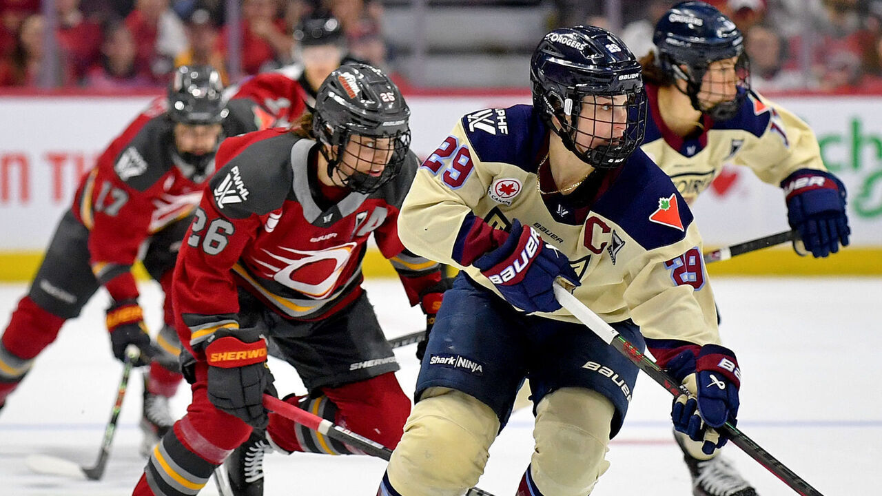 OTTAWA, ONTARIO - MAY 18: Marie-Philip Poulin #29 of the Montreal Victoire skates with the puck against Emily Clark #26 of the Ottawa Charge during the first period in game 3 of the PWHL Walter Cup Final at Canadian Tire Centre on May 18, 2026 in Ottawa, Ontario.