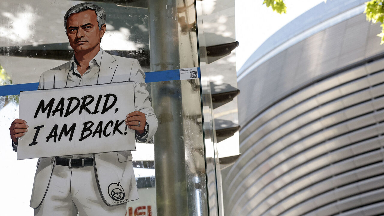 A mural by Italian urban artist Salvatore Benintende aka "TV BOY" depicting Portuguese coach Jose Mourinho is seen in front of the Santiago Bernabeu stadium in Madrid on May 21, 2026. Benfica coach Jose Mourinho confirmed on May 17, 2026 his agent Jorge Mendes has been in contact with Spanish giants Real Madrid. The veteran Portuguese coach, 63, has been strongly linked with a sensational return to the Santiago Bernabeu 13 years after he left Los Blancos. Mourinho said he personally has not had any contact with Madrid president Florentino Perez, or anyone else at the club, and that his future will be decided in the coming week. / RESTRICTED TO EDITORIAL USE - MANDATORY MENTION OF THE ARTIST UPON PUBLICATION - TO ILLUSTRATE THE EVENT AS SPECIFIED IN THE CAPTION