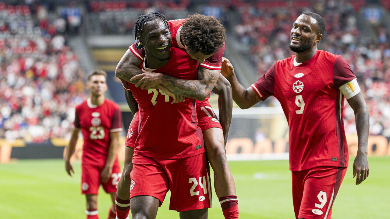 VANCOUVER, CANADA - JUNE 17: Promise David #24 of Canada celebrates with teammates Tajon Buchanan #17 and Cyle Larin #9 after scoring a goal against Honduras during the second half of 2025 Concacaf Gold Cup Group B action at BC Place on June 17, 2025 in Vancouver, Canada.