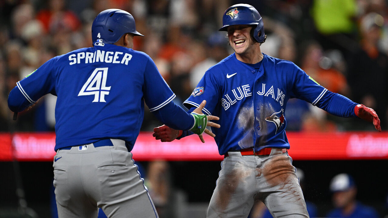 BALTIMORE, MD - MAY 29: Ernie Clement #22 of the Toronto Blue Jays, right, celebrates with George Springer #4 after scoring the go-ahead run in the eighth inning against the Baltimore Orioles at Oriole Park at Camden Yards on May 29, 2026 in Baltimore, Maryland.