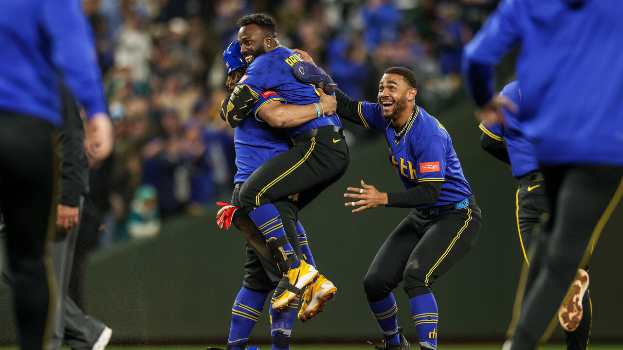 SEATTLE, WASHINGTON - MAY 29: Randy Arozarena #56 of the Seattle Mariners is swarmed by Julio Rodriguez #44 and teammates after hitting a walk off RBI double during the tenth inning against the Arizona Diamondbacks at T-Mobile Park on May 29, 2026 in Seattle, Washington.