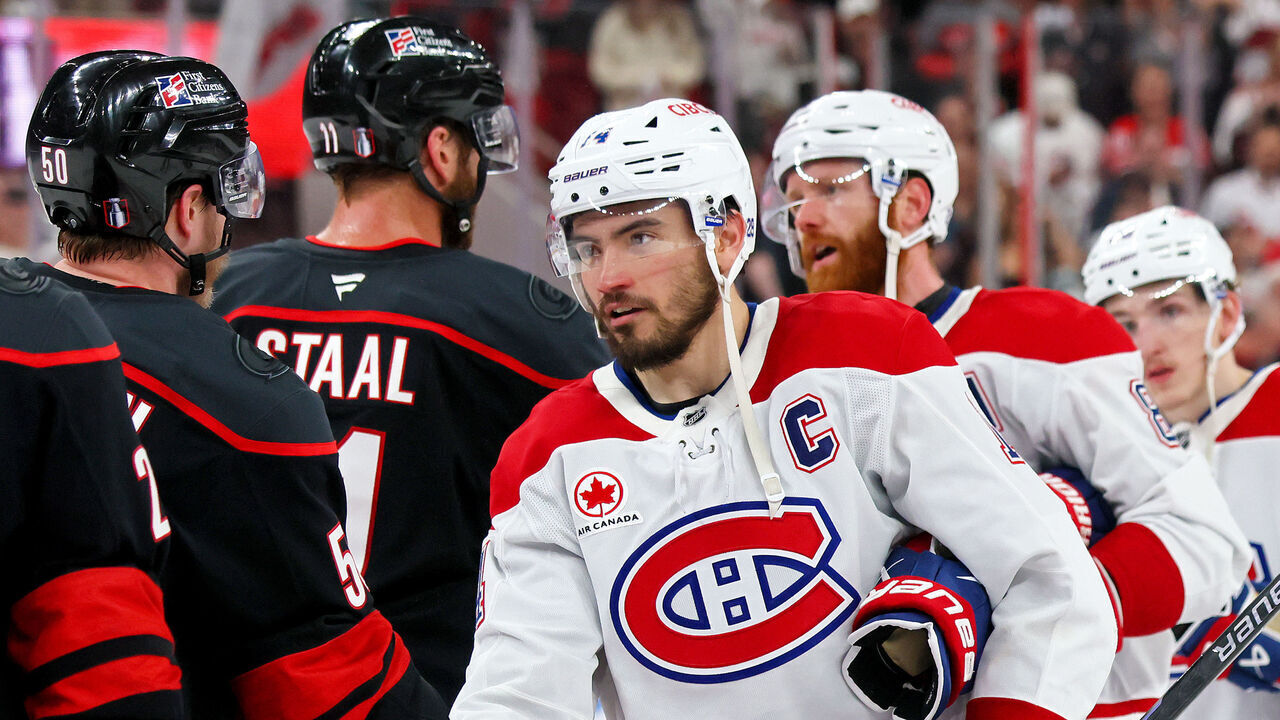 RALEIGH, NORTH CAROLINA - MAY 29: Nick Suzuki #14 of the Montréal Canadiens shakes the hand of Eric Robinson #50 of the Carolina Hurricanes following a 6-1 Carolina Hurricanes victory in Game Five of the Eastern Conference Final of the 2026 Stanley Cup Playoffs at Lenovo Center on May 29, 2026 in Raleigh, North Carolina.