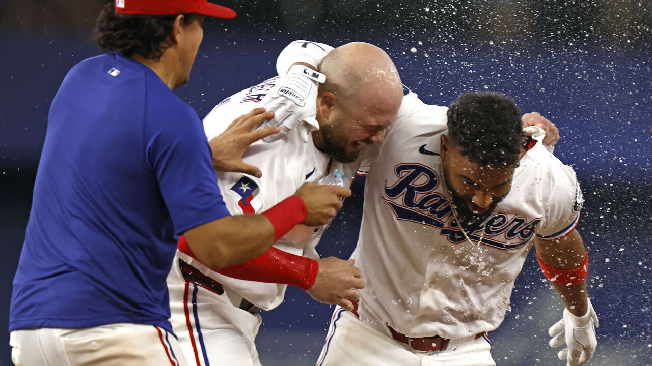 ARLINGTON, TEXAS - MAY 30: Ezequiel Duran #20 of the Texas Rangers celebrates with teammate Jake Burger #21 after Duran hit a walk off single to win the game against the Kansas City Royals at Globe Life Field on May 30, 2026 in Arlington, Texas.