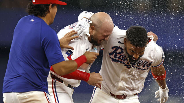 ARLINGTON, TEXAS - MAY 30: Ezequiel Duran #20 of the Texas Rangers celebrates with teammate Jake Burger #21 after Duran hit a walk off single to win the game against the Kansas City Royals at Globe Life Field on May 30, 2026 in Arlington, Texas.