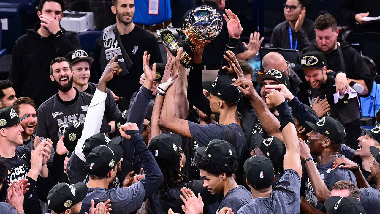 OKLAHOMA CITY, OKLAHOMA - MAY 30: Victor Wembanyama #1 of the San Antonio Spurs hoist the The Oscar Robertson Trophy with his teammates after defeating the Oklahoma City Thunder in Game Seven of the NBA Western Conference Finals at Paycom Center on May 30, 2026 in Oklahoma City, Oklahoma.