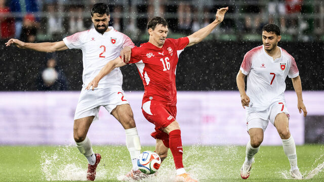 Jordan's defender #2 Mohammad Abu Hashish (L) fights for the ball with Switzerland's midfielder #16 Christian Fassnacht next to Jordan's forward #7 Mohammad Abu Zraiq (R) during a friendly match between Switzerland and Jordan ahead of the 2026 FIFA World Cup football tournament at the Kybunpark stadium, in St. Gallen on May 31, 2026.