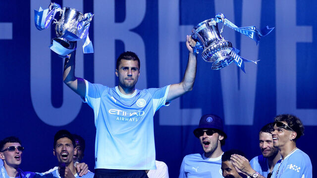 MANCHESTER, ENGLAND - MAY 25: Rodri of Manchester City lifts the Carabao Cup and FA Cup trophies as the bus carrying the men's team arrives during the After Party Celebration to mark the achievements of Manchester City men’s, women’s and academy teams during the 25/26 season at The Co-op Live Arena on May 25, 2026 in Manchester, England.