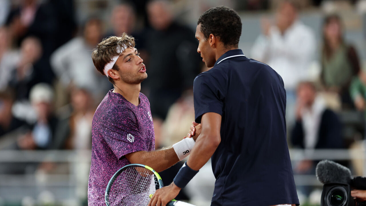 PARIS, FRANCE - JUNE 03: Flavio Cobolli of Italy shakes hands with Felix Auger-Aliassime of Canada at the net following victory during their Men's Singles quarter-final match match on Day Eleven of the 2026 French Open at Roland Garros on June 03, 2026 in Paris, France.