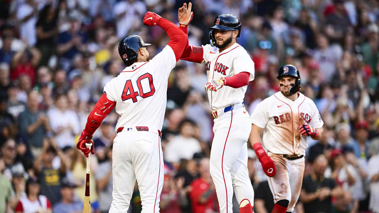 BOSTON, MASSACHUSETTS - JUNE 03: Wilyer Abreu #52 of the Boston Red Sox is greeted at home by Willson Contreras #40 after hitting a two-run home run to bring Caleb Durbin #5 home in the third inning against the Baltimore Orioles at Fenway Park on June 03, 2026 in Boston, Massachusetts.