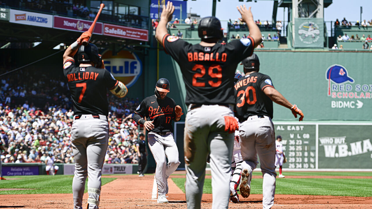BOSTON, MASSACHUSETTS - JUNE 04: Colton Cowser #17 of the Baltimore Orioles, Samuel Basallo #29, and Leody Taveras #30 score off a double hit by Coby Mayo #16 (not pictured) in the first inning against the Boston Red Sox at Fenway Park on June 04, 2026 in Boston, Massachusetts.