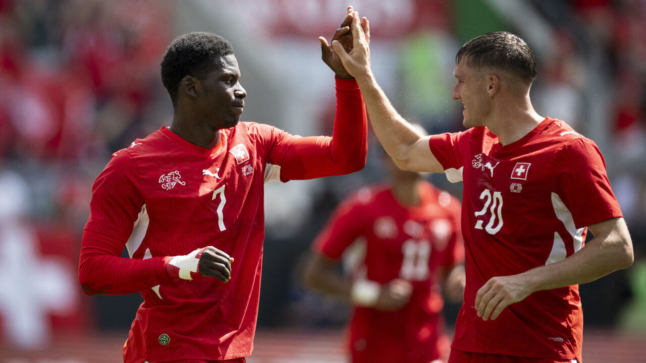 Switzerland's forward #7 Breel Embolo (L) celebrates with Switzerland's midfielder #20 Michel Aebischer scoring his team's first goal during a friendly football match between Switzerland and Jordan ahead of the 2026 FIFA World Cup football tournament at the Kybunpark stadium in St. Gallen on May 31, 2026.