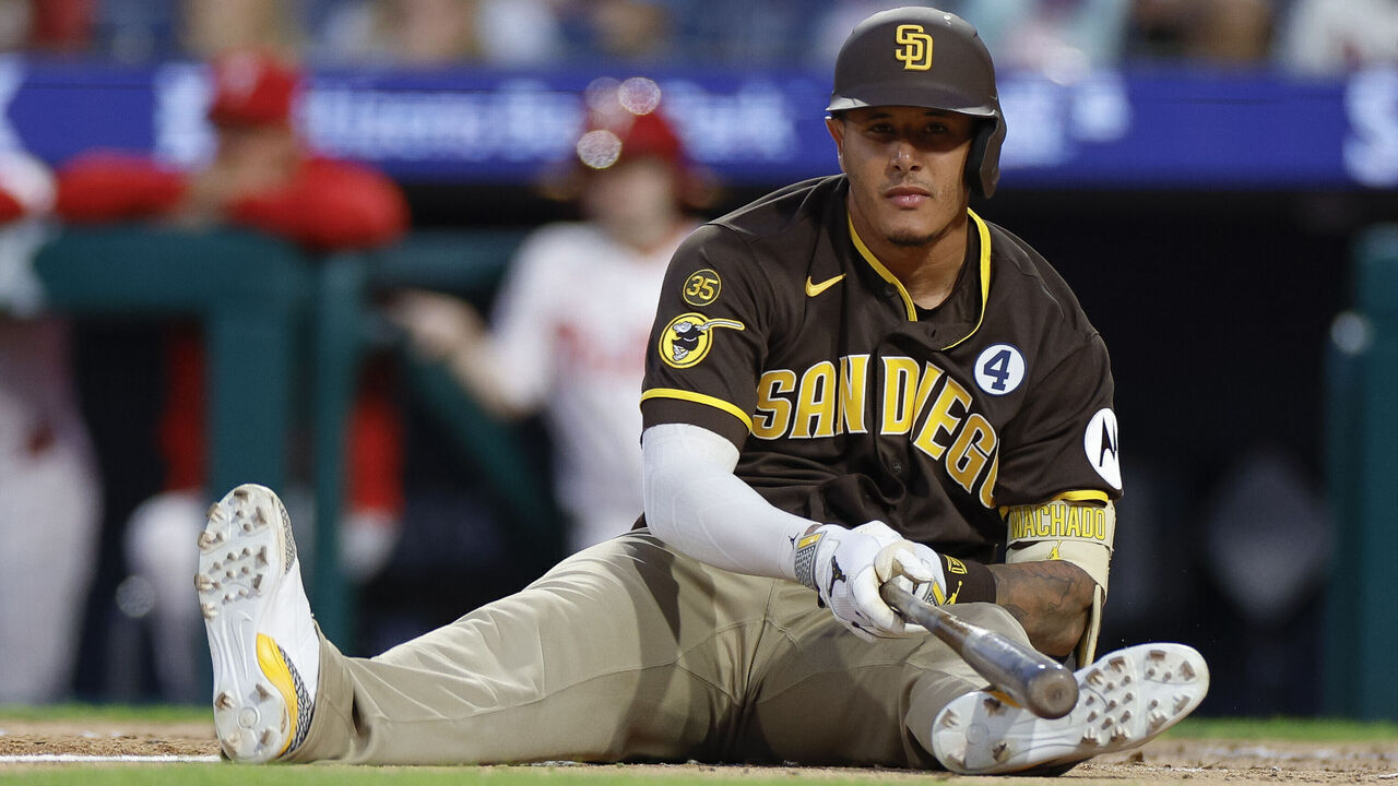 PHILADELPHIA, PENNSYLVANIA - JUNE 2: Manny Machado #13 of the San Diego Padres sits on the ground after an inside pitch in the sixth inning during a game against the Philadelphia Phillies at Citizens Bank Park on June 2, 2026 in Philadelphia, Pennsylvania.