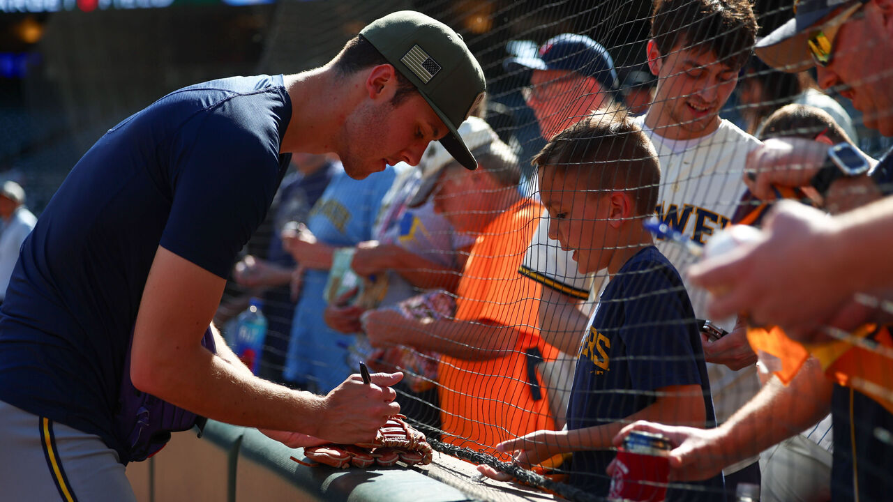 MINNEAPOLIS, MN - MAY 15: Jacob Misiorowski #32 of the Milwaukee Brewers signs an autograph for a fan prior to the game between the Milwaukee Brewers and the Minnesota Twins at Target Field on Friday, May 15, 2026 in Minneapolis, Minnesota.