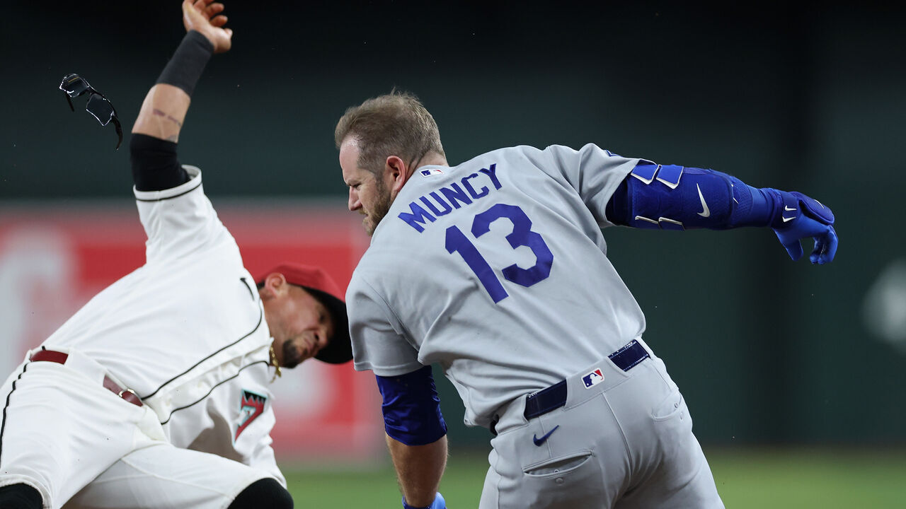 PHOENIX, ARIZONA - JUNE 04: Max Muncy #13 of the Los Angeles Dodgers collides with Ildemaro Vargas #6 of the Arizona Diamondbacks at first base during the fifth inning of the MLB game at Chase Field on June 04, 2026 in Phoenix, Arizona.